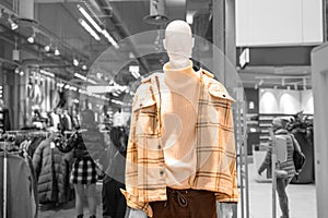 Men& x27;s and women& x27;s clothing store. Mannequins dressed in bright winter stylish women& x27;s clothing in a mall