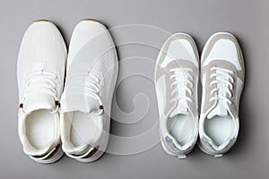 Men's and women's sneakers on a colored background top view. Sport shoes.