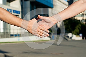 Men shaking hands on building background