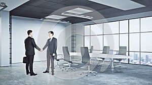 Men shaking hands in conference room