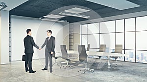 Men shaking hands in meeting room