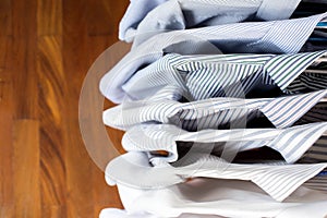 Men shirts hanging on rack in a row, Top view