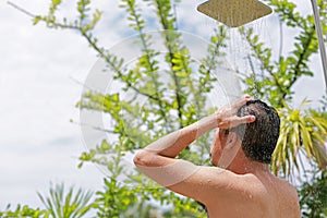 Men showering outdoor in the resort.