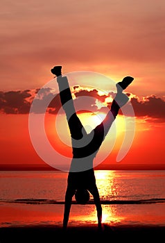 Men silhouette standing on hands