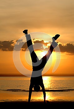 The men silhouette standing on hands