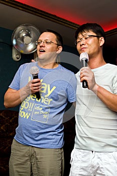 Men singing karaoke