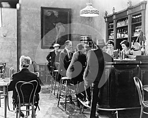 Men sitting around a counter in a bar