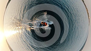 Men are sitting in the floating autoboat in a top view zoom-in