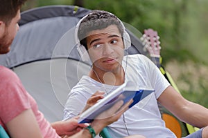 men sitting in front tent