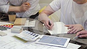 Men sitting in office working on building project laptop