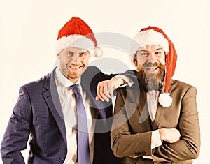 Men in smart suits and Santa hats on white background