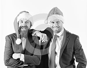 Men in smart suits and Santa hats on white background