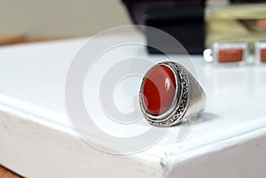 men spiritual stone ring isolated on white macro focus blurry background red gemstone closeup