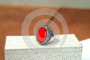 men spiritual stone ring isolated on white macro focus blurry background red gemstone closeup