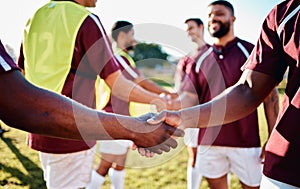 Men, sports and handshake for greeting, introduction or sportsmanship on the grass field outdoors. Sport team shaking