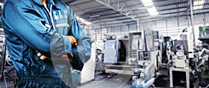 Men is standing with arms folded in a storage facility or warehouse