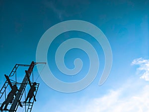 Men standing high up on a makeshift scaffold tower. the worker rebuild an exterior section of a house under renovation and