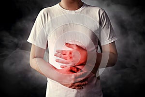 Men stomach ache on smoke background