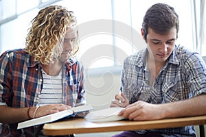 Men, students and reading textbook in college with teamwork for education assignment, project or research. Male people