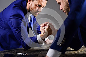 Men in suit or businessmen with tense faces compete