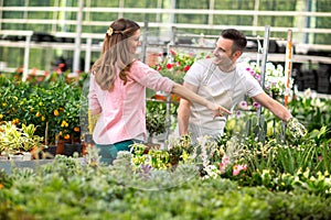 Men surrounded by plant in greenhouse