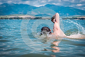 Men Swimming in a Lake