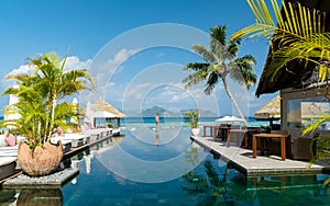 men at a swimming pool at a luxury hotel with a view over the ocean