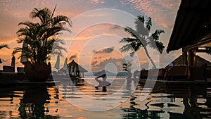 men at a swimming pool at a luxury hotel with a view over the ocean,Luxury pool tropical resort