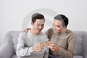 Men talk concept. Two young male friend gathering, chatting and eating at home