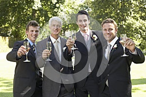 Men Toasting Champagne Flutes At Wedding