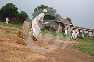 Men in traditional attire play cricket, Sarkhej Roza