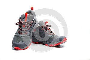 Men trekking shoes isolated on white background. Gray-red hiking shoes. Safety footwear for climbing. Adventure gear. Lightweight