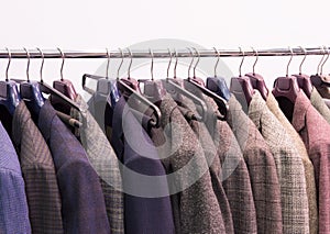 Men trousers and jackets on hangers . Selective focus.