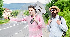 Men try stop car thumb up. Travel by autostop. Hitchhiking cheapest ways traveling. Hitchhiker meet friend. Travelers