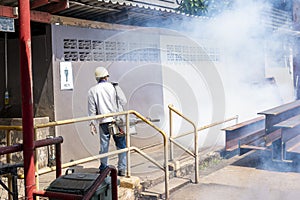 Men are using a fogging machine to get rid of mosquitoes and insects in industrial factories