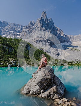 men visiting Lago di Sorapis in the Italian Dolomites,blue lake, Lake Sorapis Dolomites, Italy.