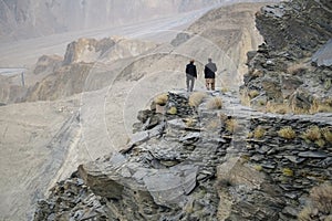 Men walking along Karakoram mountain range