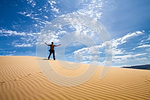 Men walking in the mongolian desert sand dunes. Young men walking golden sand on a bright summer day, Mongolia holliday
