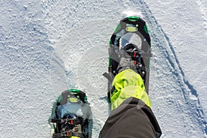 men wallking in snow with snowshoe