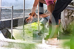Men washing their feet making ablution on a fount in a mosque in Male,  Maldives photo