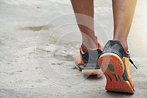Men wear running shoes on the ground.