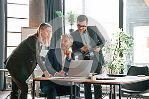 Men and woman indoors. Group of business people are working in the modern office