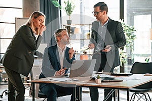 Men and woman indoors. Group of business people are working in the modern office