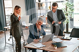 Men and woman indoors. Group of business people are working in the modern office