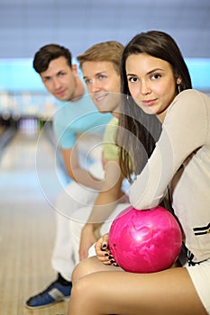 Men and woman sit in bowling club