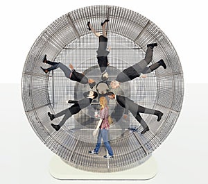 Men and women of different nationalities in a hamster wheel