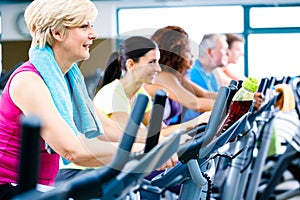 Men and women doing fitness spinning for sport