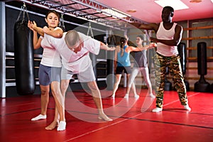 Men and women at group self-defense training