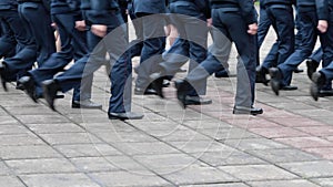 Men and women in military uniforms march across the parade ground on a cloudy summer day. Federal Service for the