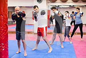 Men and women practicing boxing punches